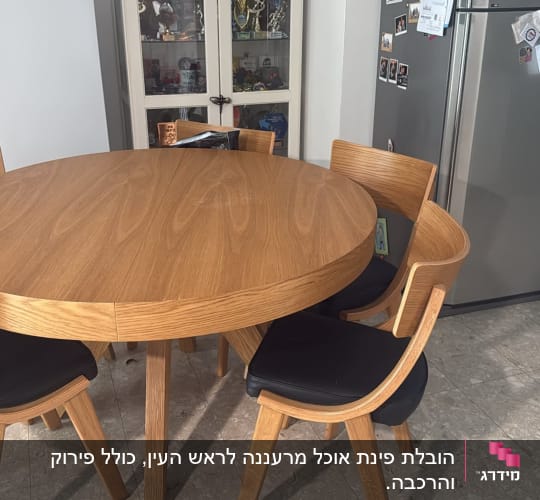 שולחן עגול עם כיסאות ומקרר במטבח